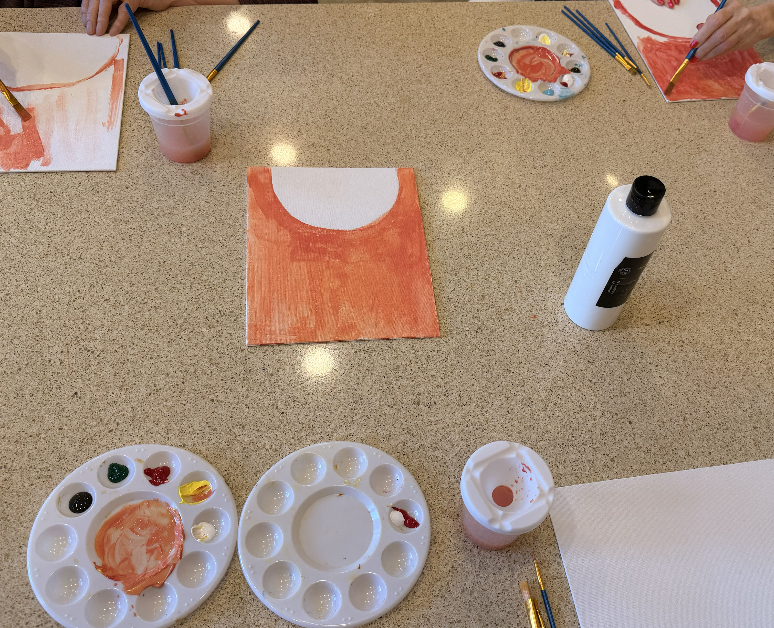 Paint station viewed from above during a group workshop.
